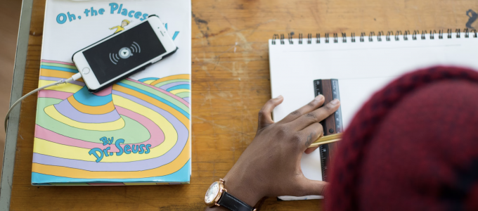 Image - student working with pencil, ruler and paper next to book and smarphone