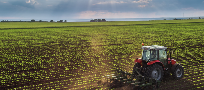 Image - farmer driving tractor in field